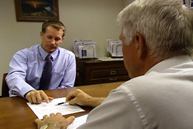 Men reviewing document: online training Men reviewing document: online training
