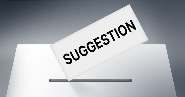 Sheet of paper with the word "Suggestion" on it being put into the slot at the top of the box