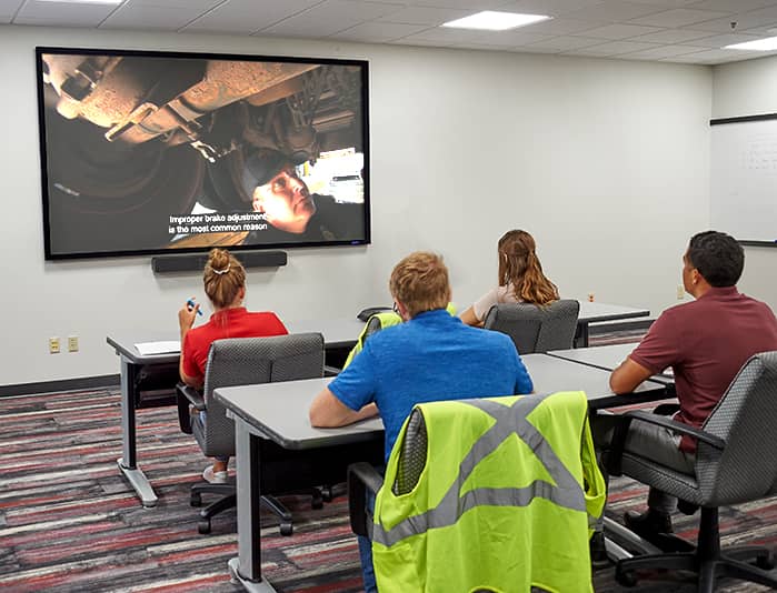 Video-based employee training being administered to employees in a classroom setting