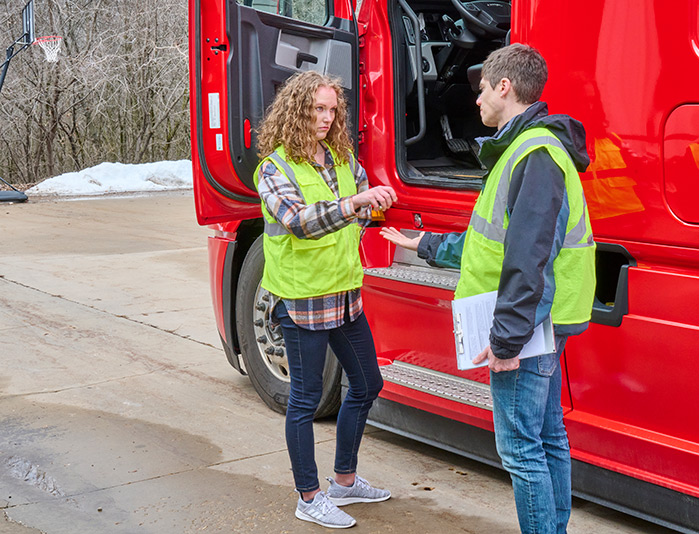 CDL supervisor taking keys from a commercial driver suspected of drug or alcohol impairment, emphasizing the importance of DOT Reasonable Suspicion Training.